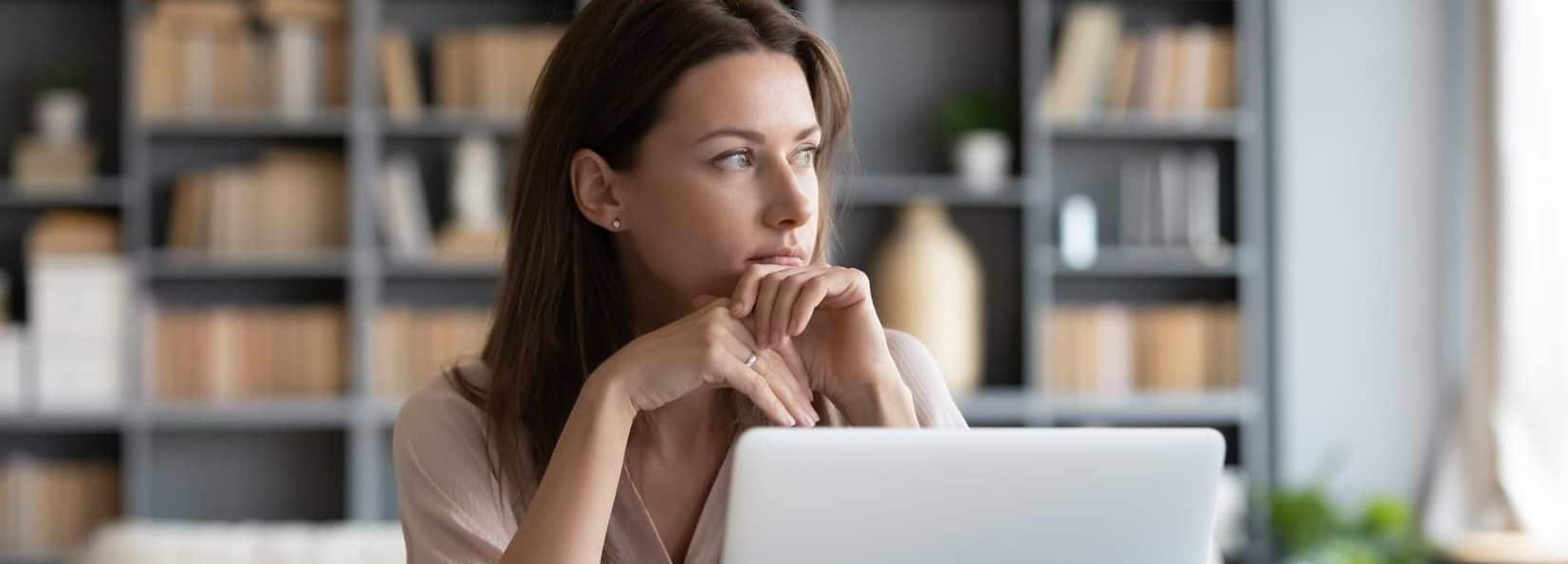Kvinna vid dator som läser på om lån utan inkomst